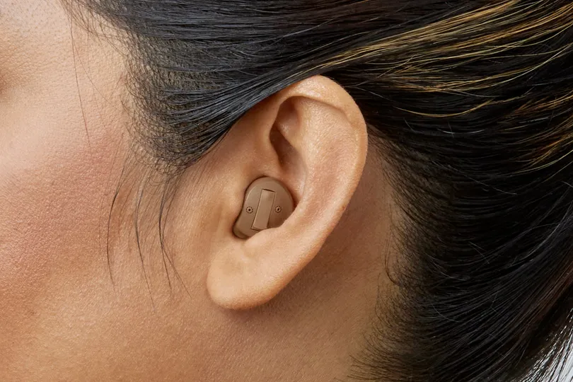 In the ear — half shell hearing aid shown worn in the ear