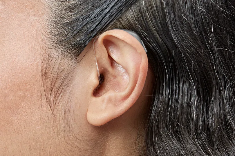 Receiver in the canal / receiver in the ear hearing aid shown worn in the ear